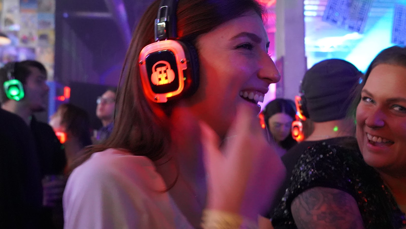 SE2 Silent Disco photo showing guests wearing glowing wireless headphones with music-channel moment, asset 5WMPJA.