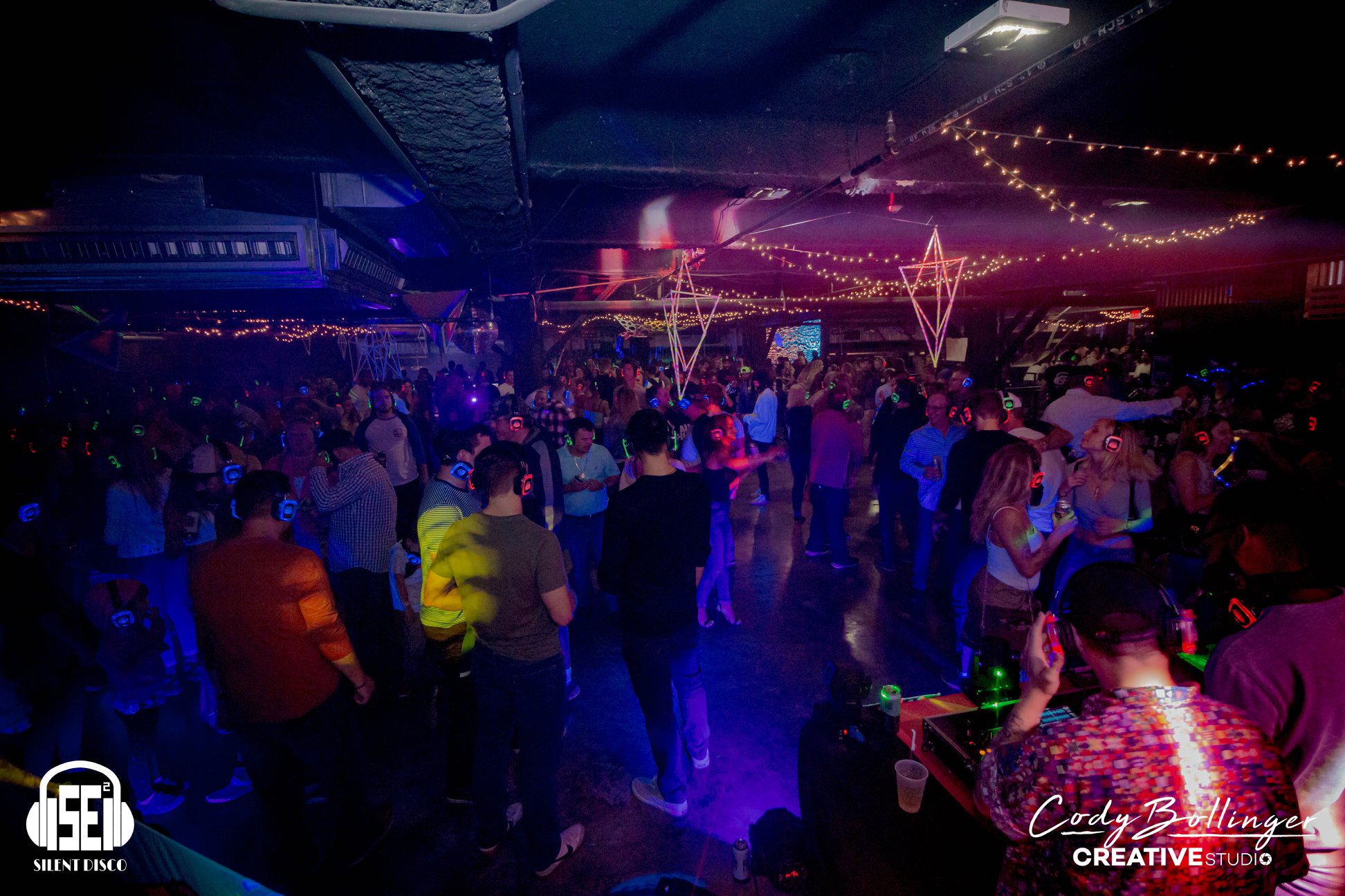 SE2 Silent Disco photo showing guests wearing glowing wireless headphones with dance-floor energy, asset 5NLMRC.